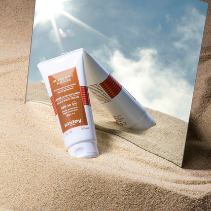 Super Soin Solaire - Silky Body Cream SPF 30 SOLAIRES SUPER SOIN BODY SPF30 200ML on sand with mirror, sun protection.