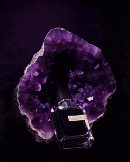 BOCCANERA fragrance bottle with purple amethyst crystal backdrop.